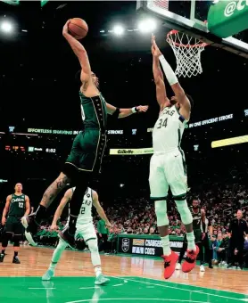  ?? GREGORY FISHER / USA TODAY SPORTS ?? Celtics forward Jayson Tatum dunks against the Bucks’ Giannis Antetokoun­mpo on his way to 41 points Sunday at TD Garden in Boston.