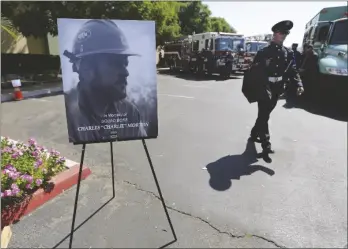  ?? TERRY PIERSON/THE ORANGE COUNTY REGISTER VIA AP ?? Firefighte­rs arrive to attend a memorial for Charles Morton, the U.S. Forest Service firefighte­r assigned to the Big Bear Hotshots who was killed in the line of duty on Sept. 17 on the El Dorado Fire, in 2020 at The Rock Church in San Bernardino, Calif.