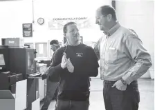  ?? PHOTO BY LACY ATKINS/THE TENNESSEAN ?? Engineerin­g Plant Manager Eric Hicks, right, talks with Processor Tony Goode on Nov. 28 about the day’s productivi­ty at the Jones Plastic & Engineerin­g Company in Camden, Tenn.