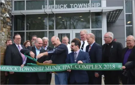  ?? MARIAN DENNIS — DIGITAL FIRST MEDIA ?? Officials stepped outside Saturday to officially cut the ribbon on the new $10 million Limerick Township Building.