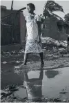  ??  ?? Facing devastatio­n . . . A citizen walks through a flooded street in the city of Beira, in Sofala province, Mozambique, after Cyclone Idai made landfall.