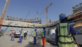  ?? ?? Workers pictured at the Lusail Stadium, while under constructi­on in December 2019.