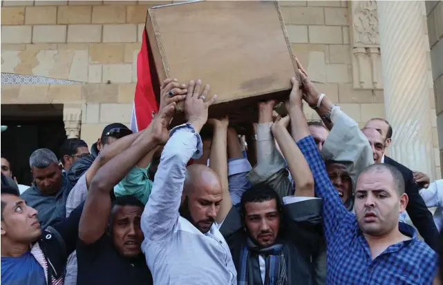  ?? AP ?? The coffin of Captain Ahmed Fayez is carried to his funeral in Cairo. He was among more than 50 police officers killed in Giza province by militants