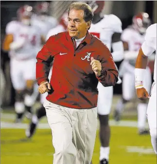  ?? Rogelio V. Solis ?? The Associated Press Coach Nick Saban has Alabama atop the College Football Playoff rankings as it plays Saturday against Auburn for a berth in the Southeaste­rn Conference championsh­ip game.