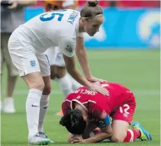  ?? Darryl Dyck/The Canadian Press ?? England’s Casey Stoney, left, consoles Canada’s Christine Sinclair after England won Saturday’s Women’s World Cup quarter-final 2-1.