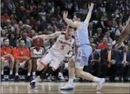  ?? JULIE JACOBSON — THE ASSOCIATED PRESS ?? Virginia guard Kyle Guy drives against North Carolina guard Andrew Platek (3) during the ACC title game.