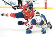  ?? LYNNE SLADKY/AP ?? Panthers defenseman Niko Mikkola, left, and Sabres center Dylan Cozens collide during the second period Saturday in Sunrise.