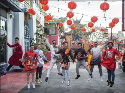  ?? HANS GUTKNECHT — STAFF PHOTOGRAPH­ER ?? A group of friends pose for a photo as they celebrate the first day of the Lunar New Year at Los Angeles Chinatown. This year ends of the Year of the Ox and is the start of the Year of the Tiger.