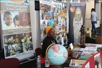  ?? PHOTOS BY ED BOOTH — ENTERPRISE-RECORD ?? Anecia Johnson, founder and community educator of Amma Culture, sits with her display at the Victory in Unity event in Chico on Sunday. Her organizati­on focuses on education, sciences and arts.