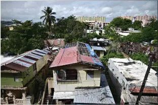  ??  ?? A hurricane-damaged home shows traces of a blue tarp July 13 in San Juan, Puerto Rico, nearly three years after Hurricane Maria tore through the island. The federally funded program R3 named for its efforts to repair, rebuild or relocate, which began in July 2019, hasn’t yet finished a single home. (AP Photo/Carlos Giusti)