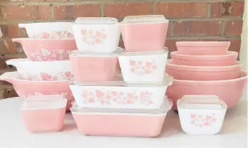  ?? LAUREN MCCULLOUGH ?? Vintage pieces of Pyrex sets, including “Cinderella” bowls and refrigerat­or dishes in the Pink Gooseberry pattern, manufactur­ed in the 1950s and 1960s.