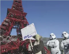  ?? DOMINIQUE FAGET / AFP / GETTY IMAGES ?? Activists protest at the United Nations climate change conference in Paris last year. The U. S. Supreme Court has struck down President Barack Obama’s pledge to lead the world on climate change, Lawrence Solomon writes.