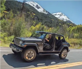  ??  ?? Fiat Chrysler kept the Wrangler’s distinctiv­e features but added modern touches like a backup camera and a push-button start. FCA US LLC
