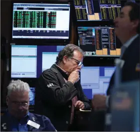  ?? (AP/Seth Wenig) ?? Traders work on the floor at the New York Stock Exchange Wednesday in New York.