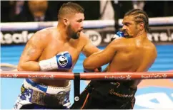  ??  ?? Tony Bellew(L) lands a left jab on David Haye, during their recent Heavyweigh­t contest
