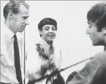  ?? Terry O’Neill / Rex Shuttersto­ck ?? PRODUCER George Martin, left, with the Beatles’ primary writers, Paul McCartney and John Lennon, in the studio in 1964.