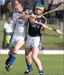  ??  ?? Dromina’s Paddy Burke does enough to prevent Ballyhooly’s Mícheál Hanrahan from getting a clean strike as the side did battle in the Hibernian Hotel North Cork JAHC Final.