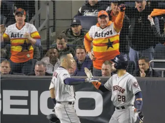  ?? Seth Wenig / Associated Press ?? Houston Astros shortstop Carlos Correa (1) celebrates with Robinson Chirinos (28) after hitting a threerun home run against the New York Yankees in the sixth inning of Game 4 of the ALCS.