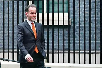  ?? Aaron Chown/PA via AP ?? Chris Pincher is seen walking on Downing Street, London. Britain’s government is facing another boozy scandal after the deputy chief whip resigned from his post after a drunken incident this week. Prime Minister Boris Johnson faced calls on Friday to expel Chris Pincher from the Conservati­ve Party.