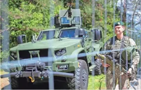  ?? MINDAUGAS KULBIS/AP ?? Soldiers stand guard at a fence surroundin­g the venue of the NATO summit Sunday in Vilnius, Lithuania.