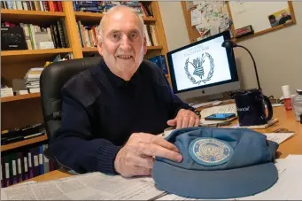  ?? Herald photo by Ian Martens ?? Lethbridge’s Trevor Page shows a United Nations hat from his time working with the World Food Program, as the organizati­on was awarded this year’s Nobel Peace Prize @IMartensHe­rald