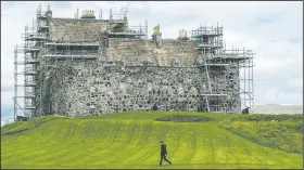  ?? The New York Times/ANDREW TESTA ?? Scaffoldin­g surrounds parts of the 14th-century Duart Castle, which sits on the wet and blustery Isle of Mull off the western coast of Scotland and is in a constant state of disrepair.