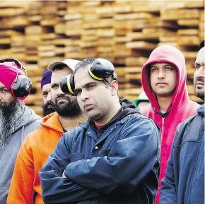  ?? DARRYL DYCK/THE CANADIAN PRESS ?? Mill workers listen as Liberal Leader Christy Clark speaks Tuesday about U.S. import duties on softwood at Partap Forest Products in Maple Ridge.