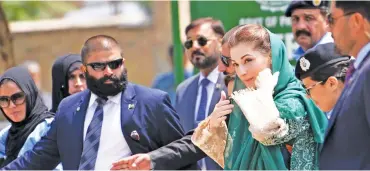  ?? (AFP) ?? This file photo shows Maryam Nawaz (centre) escorted by security personnel on her arrival for an appearance before an anti-corruption commission at the Federal Judicial Academy, in Islamabad on July 5
