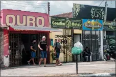  ?? ?? Gold stores line a street Nov. 5 in Boa Vista. Attempts to crack down on illegal mining in Roraima state face fierce local resistance, despite the fact all mining in the state is illegal, but that’s a relatively new reality in the history of the state.