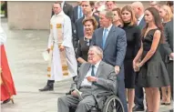  ?? JASPER COLT/USA TODAY ?? Former presidents George H.W. Bush and George W. Bush and other family members watch Saturday as Barbara Bush’s casket is placed in the hearse by her grandsons.