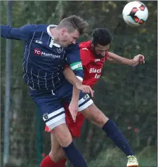  ??  ?? Ardee’s Dean Gaynor gets a head on the ball ahead of Black Bull’s Helder Mota during Sunday’s game in Townparks.