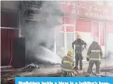  ??  ?? Firefighte­rs tackle a blaze in a building’s basement in Dajeej.