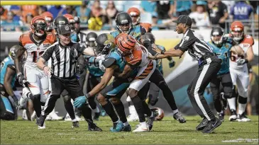  ?? PHELAN M. EBENHACK / ASSOCIATED PRESS ?? Bengals wide receiver A.J. Green (right of center) takes down Jaguars cornerback Jalen Ramsey during a fight in the first half of their game Sunday in Jacksonvil­le, Fla. Green said he regretted his actions.