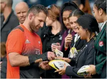  ?? PHOTO: PHOTOSPORT ?? All Blacks captain Kieran Read signs autographs after the team’s captain’s run in Auckland yesterday.