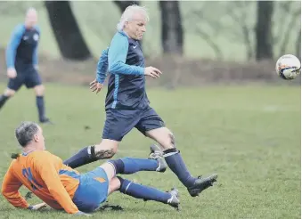  ??  ?? Over-40s action as Doxy Lad (blue) take on Trimdon Vets last weekend. Picture by Tim Richardson.