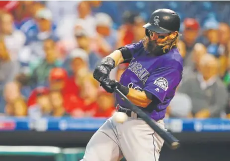  ?? Rich Schultz, Getty Images ?? Rockies center fielder Charlie Blackmon hits a two-run double against Philadelph­ia Phillies pitcher Jerad Eickhoff during the third inning Monday night at Citizens Bank Park. Blackmon went 2-for-5, had three RBIs and now is hitting .321.