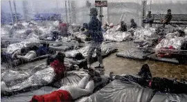  ?? COURTESY OF THE OFFICE OF REP. HENRY CUELLAR ?? This March 20 photo shows detainees in a Customs and Border Protection temporary overflow facility in Donna, Texas. President Joe Biden’s administra­tion faces mounting criticism for refusing to allow outside observers into facilities where it is detaining thousands of immigrant children.