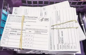  ?? Kimberly P. Mitchell / Detroit Free Press ?? A stack of vaccine cards wait to be handed out to registered residents after they receive their Moderna COVID-19 vaccines.