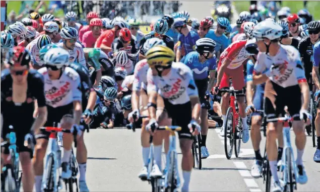  ??  ?? La parte delantera del pelotón mira hacia atrás observando las consecuenc­ias de una de las dos caídas producidas en la etapa 19ª del Tour de Francia que ganó Mohoric.