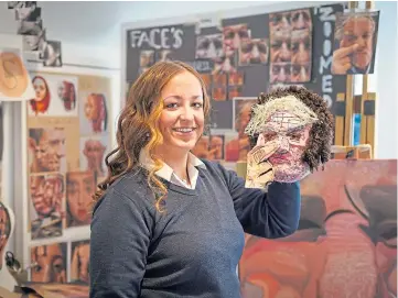  ??  ?? BUDDING ARTIST: Topaz Walker with the mask she made of her grandfathe­r Jim.