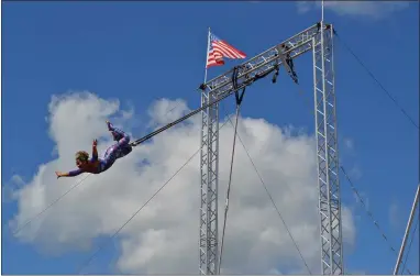  ?? PHOTOS BY SHEENA HOLLAND DOLAN — THE NEWS-HERALD ?? Lyric Wallenda, a seventh-generation acrobatics performer, shows off her aerial trapeze routine suspended more than 30 feet in the air.