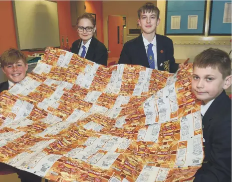  ?? ?? Charlie Hutchinson, 13, Peyton Lancaster, 12, Jay Ferry, 13, and Mitchell Peggie, 13, with a crisp packet blanket.