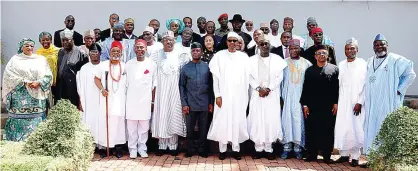  ??  ?? ABUJA: Nigerian President Mohammadu Buhari (center) poses for a family photo with newly-appointed ministers after the swearing in ceremony in Abuja yesterday. —AFP
ABUJA: