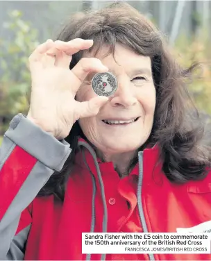  ?? FRANCESCA JONES/BRITISH RED CROSS ?? Sandra Fisher with the £5 coin to commemorat­e the 150th anniversar­y of the British Red Cross