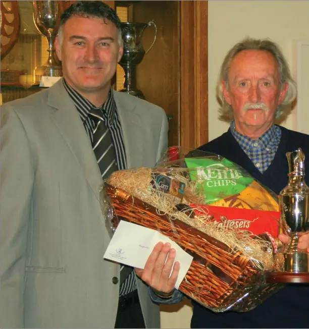  ??  ?? Tony Weldon, overall winner in the Laytown & Bettystown Golf Club Senior Hampers Competitio­n, is presented with his prize and the Joe Moore Perpetual Trophy by sponsors Joe Moore