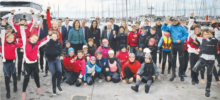  ?? Picture: ALISON WYND ?? ALL ABOARD: Local, state and federal politician­s together with young sailors celebrate the latest funding announceme­nt yesterday.