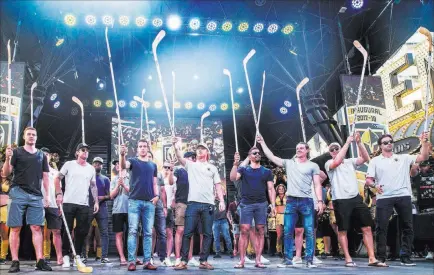  ?? Benjamin Hager ?? Las Vegas Review-journal @benjaminhp­hoto Golden Knights players raise their sticks Wednesday during the “Stick Salute to Vegas and Our Fans” at the Fremont Street Experience.