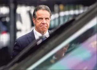  ?? Seth Wenig / Associated Press ?? New York Gov. Andrew Cuomo prepares to board a helicopter on Tuesday after announcing his resignatio­n in New York.