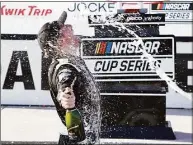  ?? Sean Gardner / Getty Images ?? Tyler Reddick celebrates with his crew by spraying champagne in victory lane after winning the NASCAR Cup Series Kwik Trip 250 at Road America on Sunday in
Elkhart Lake, Wis.