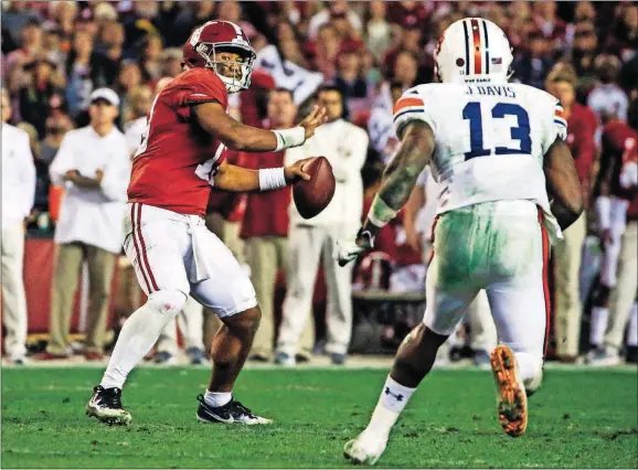  ??  ?? Alabama quarterbac­k Tua Tagovailoa (13) throws a pass against Auburn during the second half Saturday in Tuscaloosa, Ala.